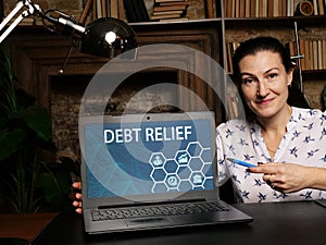 Financial concept about DEBT RELIEF with inscription on the computer. Debt reliefÂ refers to measures to reduce or refinanceÂ debt